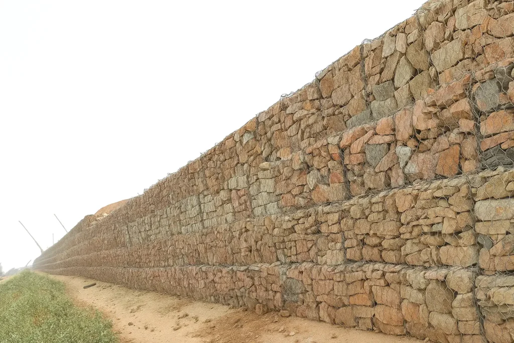 Gabion retaining wall made of rock-filled wire mesh baskets for erosion control and slope stability