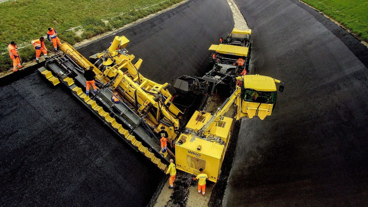 Asphalt geosynthetic canal lining installation using heavy machinery for water seepage control